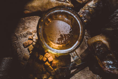 beer mug top view with sea snacks smoked fish