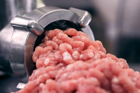 meat grinder close - up raw minced meat cookingの写真素材
