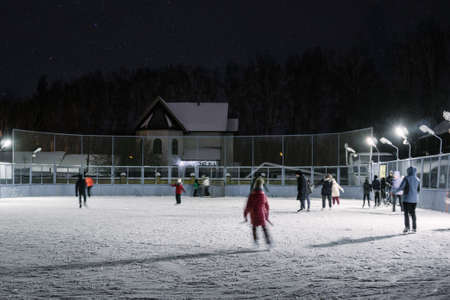 people in winter at the rink at night focus selective focus abstraction leisure recreation...