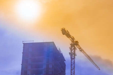 tower cranes at sunset the concept of construction of buildings silhouettes