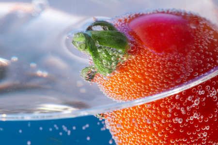 ripe tomato in water close-upの写真素材