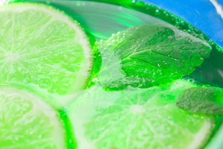 mint and lime in cocktail close-up macro in a glassの写真素材