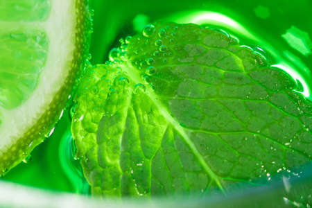 mint and lime in cocktail close-up macro in a glass