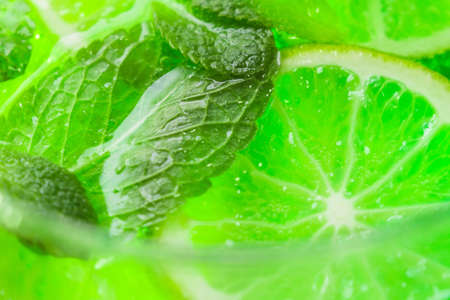 mint and lime in cocktail close-up macro in a glass