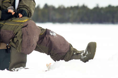 a fisherman holds the ice-fishing catch big fish bass. winter sport.