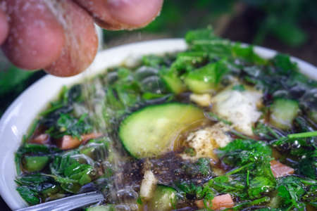 seasoning spice black pepper in soup okroshka Russian dish close-up