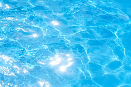 blue water background texture abstraction the sun's rays