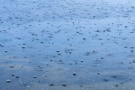 rain drops on the background texture abstraction. selective focus rain on water