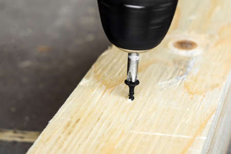 twists the screw into the Board with a screwdriver. movement selective focus construction work