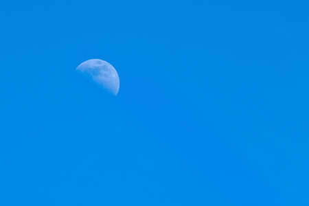 moon on a blue sky background on a bright dayの写真素材