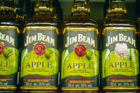 Tyumen, Russia-avg 25, 2019: Products of hypermarket sale Jim beam beverages in the store metro cash and carry. Jim beam whiskey Apple sale in the storeのeditorial素材