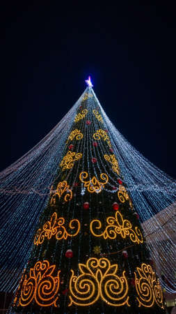 Christmas tree on a black background vertical photoの写真素材