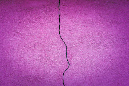 crack in concrete wall closeup purple background. Retro vintage style. color interior designの写真素材