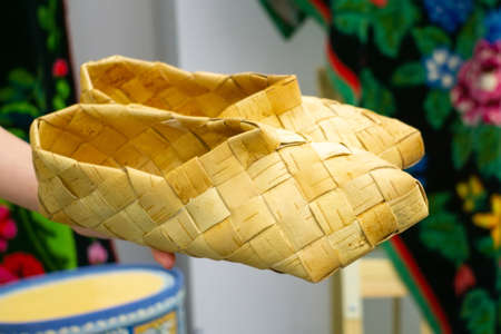 Old Bast shoes - traditional Russian footwear. vintage Russian national shoes - Lapti, bast sandals. Shoes made from bark of tree.の写真素材