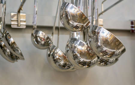 Ladle, metal, kitchen appliances background. Sale of accessories for cookingの写真素材