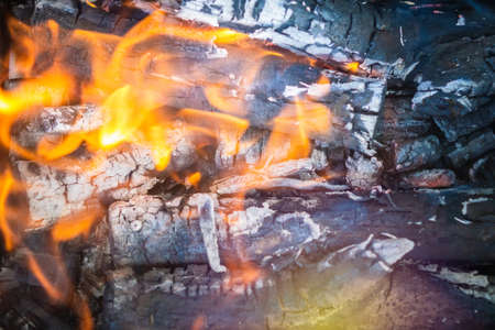Barbecue Grill Pit With Glowing And Flaming Hot Charcoal Briquettes, Cookout Background Or Texture, Close-Up, Top Viewの写真素材