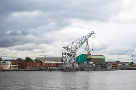 St. Petersburg, Russia, July 28: large construction crane on the Neva river. Industrial shipyard white crane.のeditorial素材