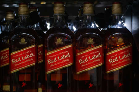 Tyumen, Russia - November 20, 2019: Johnnie Walker Red label Scotch blended whiskey on shelf for sale.のeditorial素材