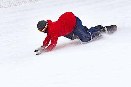 young man in a red jacket snowboarding, winter sports, winter entertainment. selective focus, extremeの写真素材