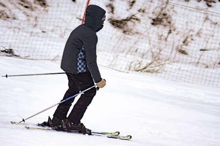 skier in a black jacket, skiing close-up, selective focus blur. winter sportの写真素材