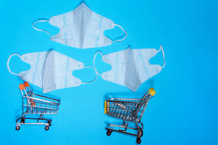 medical masks protecting the respiratory system on a blue background. the concept of buying medical...