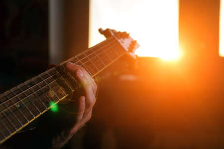 Young man playing electric guitar selective focus. home Studio rock musicの写真素材