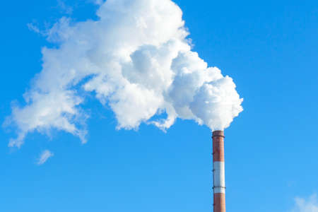 Factory smoke pipe. Smoke from a chimney against a blue sky. space for text, copy space