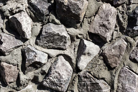 gray color of modern style design decorative uneven cracks of the real surface of the stone wall...