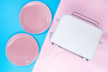 toaster and two plates Breakfast for two, top view, on a pink and blue background, place for text, mockupの写真素材