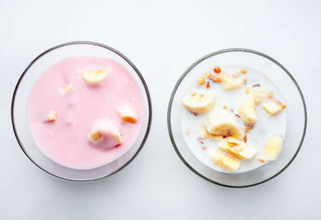 Breakfast for health and diet muesli flakes with bananas and milk and yogurt in a bowl.の写真素材