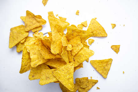 bowl of tortilla chips on white surface, top view. Mexican food.