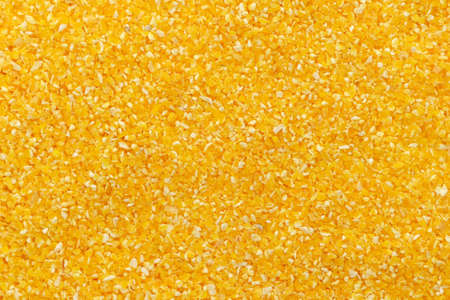 Corn grits groat background. Top view, close up. Macro texture