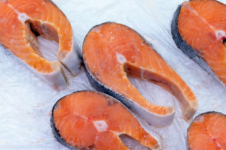 raw salmon meat is taken close-up. Sale of fresh red fishの写真素材