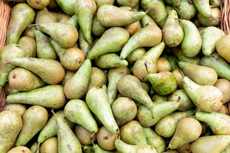 Pears are harvested in the background on the shelves in the supermarket. fruit sales in grocery...