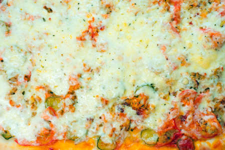 background of hot pizza with cheese top view, texture. homemade foodの写真素材