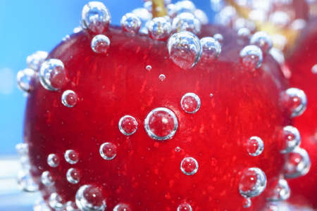 ripe cherries in soda water close up macro