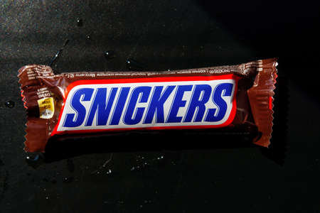 Tyumen, Russia-June 11, 2020: Snickers is a brand name chocolate bar made by the American company Mars.のeditorial素材