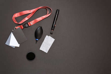 accessories for the photographer on a black background, a gray map, a napkin, a dust bag, a...