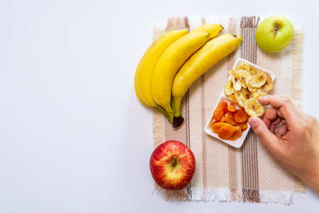 bananas apples dried apricots dried banana. healthy snacks. to view flat lay. place for text, copy spaceの写真素材