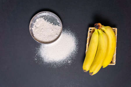 banana flour on a black background top viewの写真素材