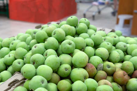 green apples on boxes in supermarket. Apples being sold at public market. Organic foodの写真素材