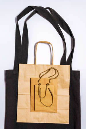 paper shopping bags on white background. Eco-friendly packaging. Shopping. ECO-friendly, reusable...