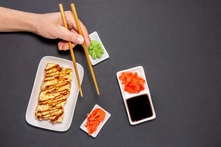 Sushi rolly, maki, nigiri Set server for two on black stone on dark background. top view flat lay