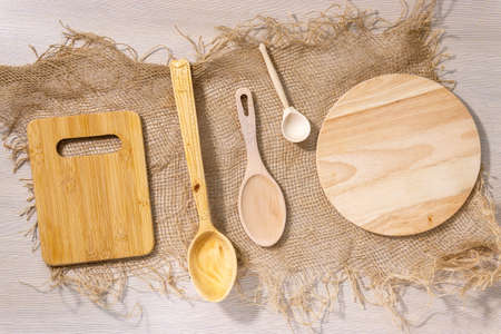 light wooden background, wooden Cutlery - a wooden spoon and cutting boards. top view flat lay