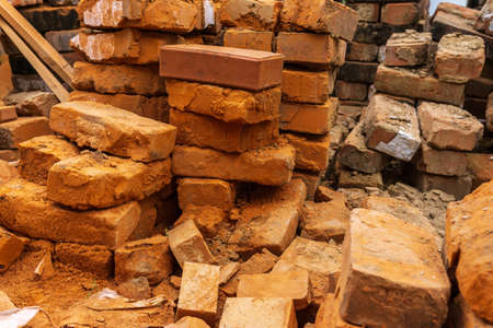 piles of brick, Red brick for building houses. Many used wall bricks laid on a pile