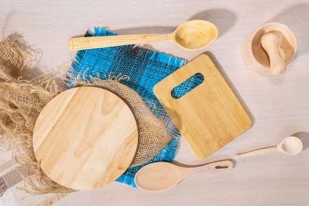 light wooden background, wooden Cutlery - a wooden spoon and cutting boards. top view flat lay