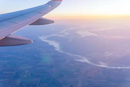 Wings of airplane above island. Traveling concept. bright sunny day