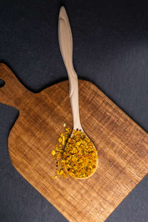 dry spices in a wooden spoon close-up on a vintage background. selective focusの写真素材