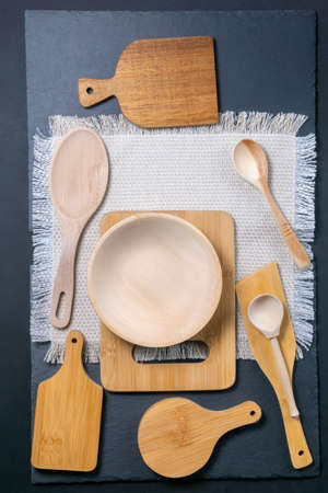 wooden kitchen appliances spoons, cutting boards. the view from the top. vertical photo