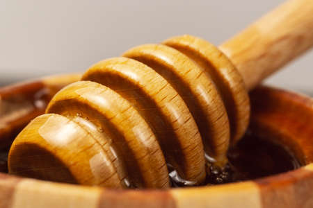 Honey in a wooden bowl. Close-up macro. Healthy organic honey. selective focusの写真素材